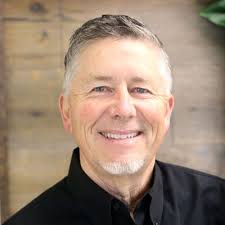 This is a roofing contractor's FB page cover photo. I count five OSHA  violations in this photo. There is no harness, no fall protection, and that  ladder does not look like it