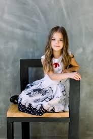Hair with large amounts of eumelanin become dark; Premium Photo Beautiful Little Girl With Long Brown Hair And Blue Eyes Sitting On The Chair On A Grey Wall Wearing A Black And White Spring Dress