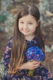 3.9 out of 5 stars with 13 ratings. Cute Baby Girl With Brunette Hair And Brown Eyes Portrait With Deep Blue Purple Wild Flowers Barefoot Wearing Stylish Colorful Flower Dress And Looking To Camera With Shining Face Stock Photo Picture