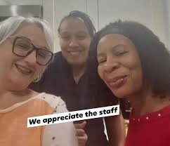 Elderly lady compliments young mailman's outfit