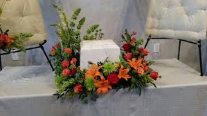 Maybe you would like to learn more about one of these? Orange And Red Around An Urn Funeral Flowers Diy Funeral Floral Funeral Flower Arrangements