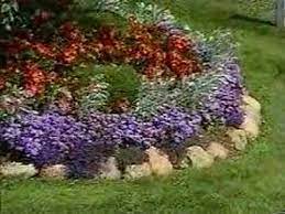 When layering your garden bed, plant tall, full shrubs in the back row. How To Garden Arranging A Flower Bed Youtube