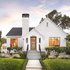 So if you're looking for some softer accents to accompany your white brick walls, opt for wood trim and doors instead of the stark black. Q A White Painted Brick Exteriors Becki Owens