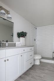 Wood effect grey tiles are spot on trend offering the natural wood effect in plank size tiles, perfect for use on your bathroom wall and floor. Wood Like Floor Tiles With White Grout Transitional Bathroom
