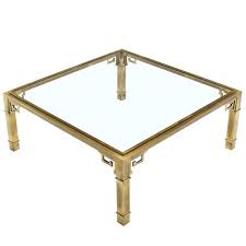 This glass coffee table reflects uniqueness on its meticulous base design, resembling clear glass on brass finish. Greek Key Square Brass Glass Top Coffee Table Mastercraft Glass Top Coffee Table Coffee Table Brass Coffee Table