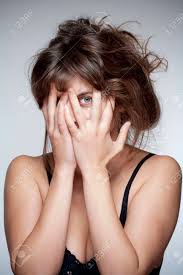 Woman Covering Face With Hand Looking With One Eye Through Fingers Stock Photo Picture And Royalty Free Image Image 33131572