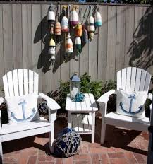 Get inspired by the ideas below! Small Nautical Theme Cottage With Nantucket Flair Nautical Landscaping Nautical Patio Beach Patio