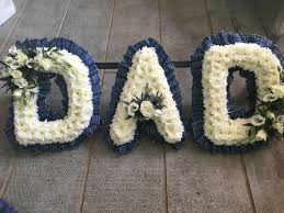 When requesting funeral flowers your dad was a wonderful man and he will be deeply missed. Scottish Funeral Tribute Tartan Ribboned Dad Funeral Flowers The Floral Art Studio Dad Funeral Flowers Funeral Flowers Funeral Floral