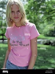 Female With Blonde Hair Wearing Pink T Shirt Saying Pale Is The New Tan With Jeans Looking To Camera Smiling Stock Photo Alamy