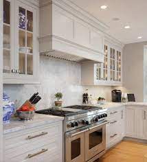 Beautiful kitchen features greige cabinets painted sherwin williams anew gray paired with marble countertops and a linear marble tiled backsplash. 10 Design Ideas For The Perfect Greige Kitchen Cabinets Simply Kitchens