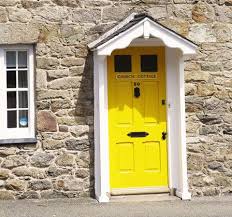 Front door in a modern house with stone elevation and wooden pergola. What Does Your Front Door Colour Say About You