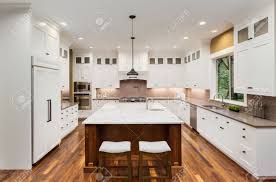 island, sink, white cabinets, pendant