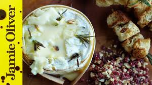 Camembert is a soft cows' milk cheese with a furry white rind speckled with beige, and a creamy, pale interior which becomes increasingly yellow as the cheese matures. Baked Camembert With Garlic Rosemary Jamie Oliver Youtube