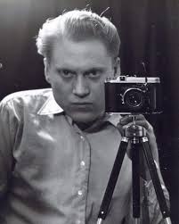 Battle of the Bulge, a German officer stands by his Brummbar in the snow.