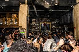 An astronaut in a space suit hangs next to a dangling chandelier made of glass bottles. The Corner The 50 Best Miami Bars Of 2020 Miami New Times