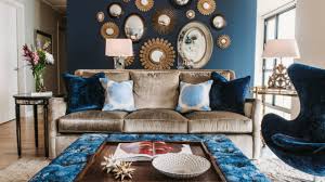 Blue velvet tufted sofa and crystal chandelier 17 Beautiful Living Room Decorating Ideas With Wall Mirrors