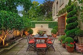 Beautiful This Just Invites One To Dine Alfresco Topiary Trees Stone The Founta Small Courtyard Gardens Courtyard Gardens Design Mediterranean Garden Design