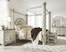 Mattress and foundation/box spring sold separately. Cassimore North Shore Pearl Silver Upholstered Poster Canopy Bedroom Set 1stopbedrooms