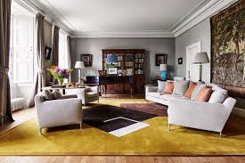 A brilliant option for bright and airy bedrooms, this shade prevents the space becoming stark and provides a soft backdrop for a mix of original arts, crafts and retro details. The Drawing Room Modern Grey Living Room Yellow Carpet Round Carpet Living Room
