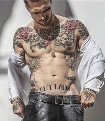 A hot lower back flourish tattoo design inked so graciously. Best Chest Tattoos Jaw Dropping Ink Masterpieces Chest Tattoo Men Lower Stomach Tattoos Cool Chest Tattoos