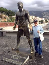 Portuguese football player cristiano ronaldo poses beneath a statue of himself during the unveling ceremony in his hometown in funchal on december 21, 2014. Cristiano Ronaldo S Statue Given A Shine By Fans Rubbing Its Groin Mirror Online