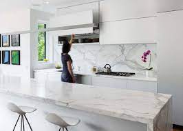 A neutral kitchen with cream cabinets, a white kitchen island with. Kitchen Design Ideas 9 Backsplash Ideas For A White Kitchen White Modern Kitchen Interior Design Kitchen Kitchen Redesign