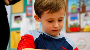 Some children play with their toys. Mylo Trinagel photographs his.