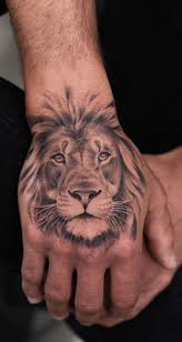 50 Eye Catching Lion Tattoos That Ll Make You Want To Get Inked Lion Hand Tattoo Lion Head Tattoos Hand Tattoos