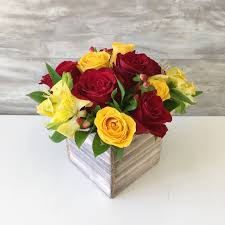 A flower growing during a hill country spring. Small Wood Box Arrangement With Red And Yellow Roses And Yellow Alstroemerias Yellow Rose Flower Red Flower Arrangements Yellow Flower Arrangements