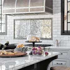 Just a like a beautifully painted feature wall in any other room of a home, the area above the. Mirrored Tiles Behind Stove Design Ideas