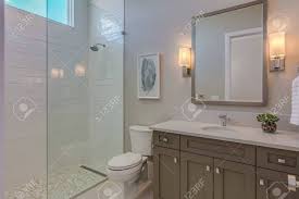 Walkway by day, shower by night. New And Simple Bathroom With Doorless Shower Stock Photo Picture And Royalty Free Image Image 144198341