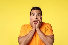 Premium Photo | Surprised and speechless young shocked handsome man in t-shirt, gasping amazed, drop jaw and stare camera popped eyes, grab face from amazement, standing stupor from realisation, yellow background