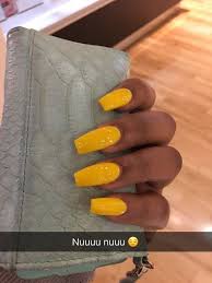Coffin shaped nails (also known as ballerina nails) feature long length and squared tips. Yellow Coffin Nails On Dark Skin On Stylevore