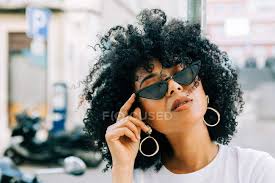 Relax and stay calm with ebay.com. Pretty Ethnic Woman In White T Shirt And With Black Curly Hair Over Black Glasses Blurred Background Golden Stock Photo 295760006