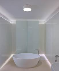 The modern, staggered brass chandelier in this example by interior designer lindye galloway is the perfect edgy touch for an elegant bathroom. Top 10 Bathroom Lighting Ideas Design Necessities Ylighting
