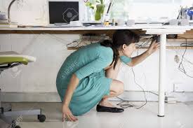 All kidding aside, it's a pretty cool idea. Woman Adjusting Cables Under Desk Stock Photo Picture And Royalty Free Image Image 18885451