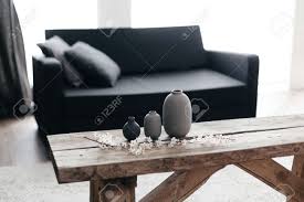 Get free shipping on qualified rustic coffee tables or buy online pick up in store today in the furniture department. Minimalistic Home Decor On Rustic Coffee Table Over Black Sofa Stock Photo Picture And Royalty Free Image Image 98891955