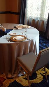 J J S Table Setting At The Marlowe Silver Tablecloth Gold Charger Cream Napkin Gold And Silver Chairs Pops Of Cobalt Silver Tablecloth Chair Home Decor