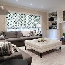 Family Room Light Tan Walls W White Moldings Gray Colored Area Rug White Ottoman Living Decor Living Room With Fireplace Tan Walls