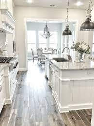 The grey stone wall sets the tone. Grey Floors White Cabinets And Light Counter Tops Similar To Our Kitchen White Kitchen Design Kitchen Design Kitchen Cabinet Design