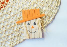 This popsicle stick scarecrow makes a festive refrigerator magnet. Popsicle Stick Scarecrow Magnet Craft Great For Kids