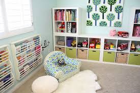 In One Corner Of This Cool Playroom A Land Of Nod Chair Pier One Pouf And A Hide Rug Found At Cost Playroom Storage Furniture Playroom Storage Kids Playroom