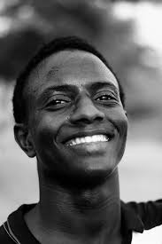 Cheerful young black man smiling at camera · Free Stock Photo