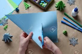Here, you can use scraps of wrapping paper, tissue paper, textured craft paper, or simply different colored cardstock. Making Origami 3d Xmas Tree With Paper For Decoration Or Greeting Card Merry Christmas And Happy New Year Children S Diy Concept Handmade Crafts On Holiday With Your Own Hands Stock Photo Picture
