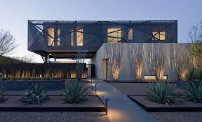 Tinted film on the lofty triangular windows conspired to hide the sonoran desert views, and the whole place was very, very brown, from the walls to the carpet to the painted wooden beams. Modern Desert House Designed For Enjoyable Desert Living Architecture Beast
