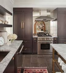 dark brown kitchen cabinets with brass