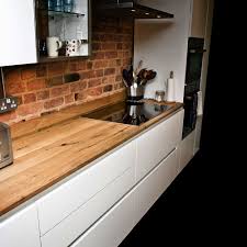 The dark grey in frame shaker door has been given a free standing look, with classic solid oak worktops. Bespoke Earthy Oak Resin Worktops Earthy Timber Sussex Uk