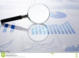 accounting data charts and magnifying glass stock photo