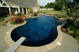 With A Diving Board Deep And Shallow Zones And Deck Jets This Swimming Pool Makes The Ultimate Staycation Spot Pool Water Features Pool Swimming Pool House
