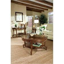 A rich cinnamon finish gives this piece its signature color, covering a frame constructed from fine hardwood solids and cherry veneers. T1052 45 Magnussen Home Furniture Aidan Round Cocktail Table